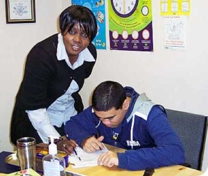 Caregiver assisting an adult with a developmental disability at Mary Centre Community Support Group